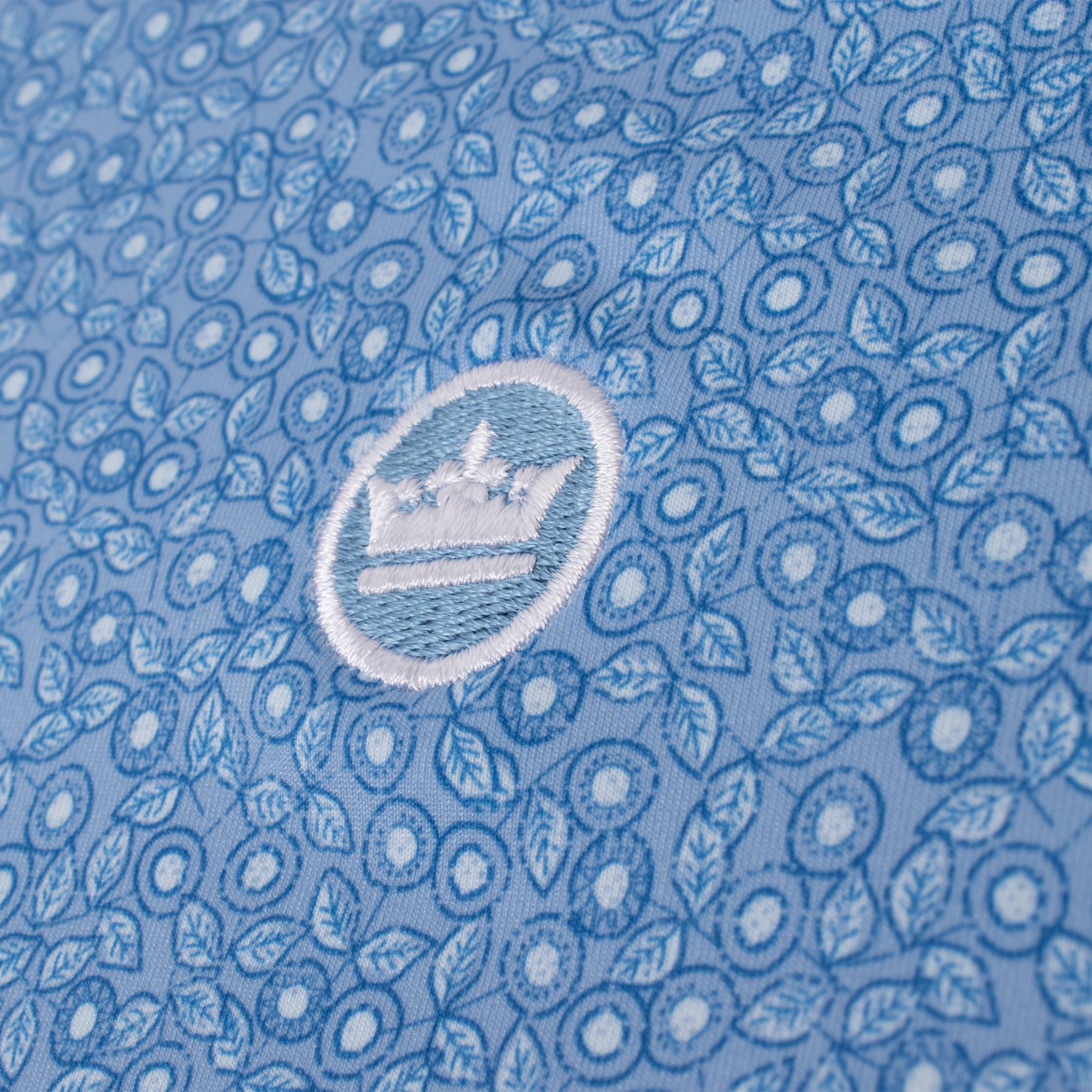 Close-up of Peter Millar logo on chest of Bristol Floral Performance Polo Shirt – luxury mens golf apparel