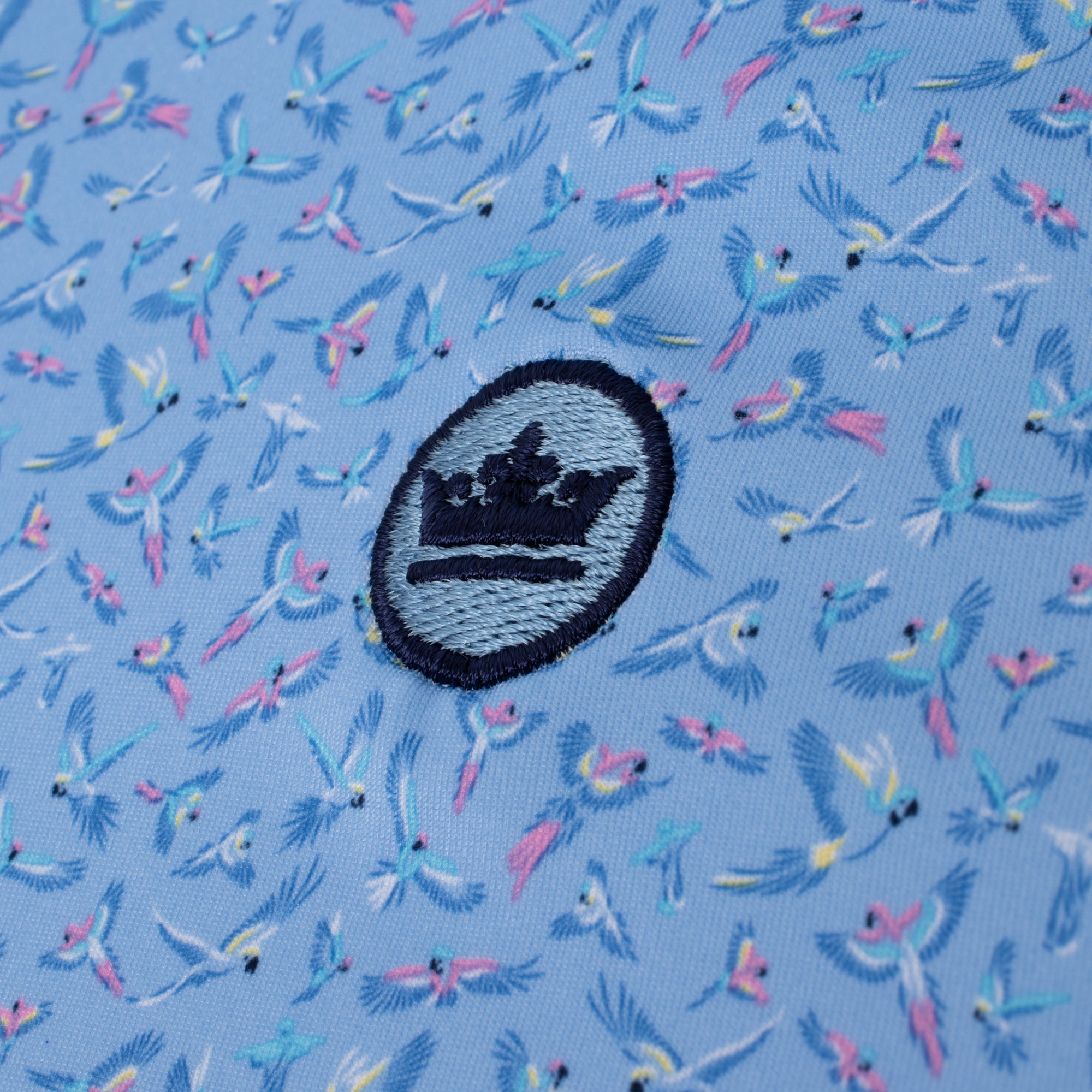 Peter Millar logo close-up on chest of Macaw Country Performance Polo Shirt – premium golf polo for men