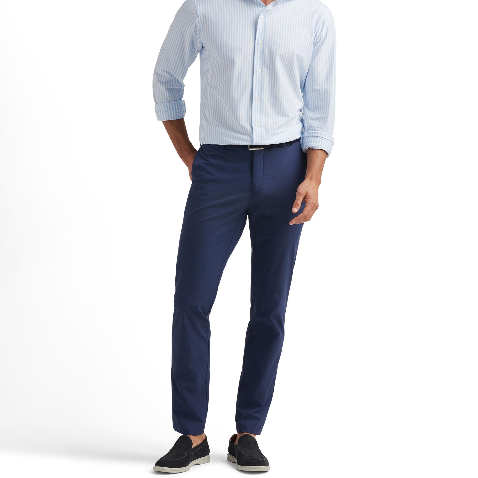 Male model showcasing Peter Millar Surge Performance Trousers in Navy – slim fit golf trousers