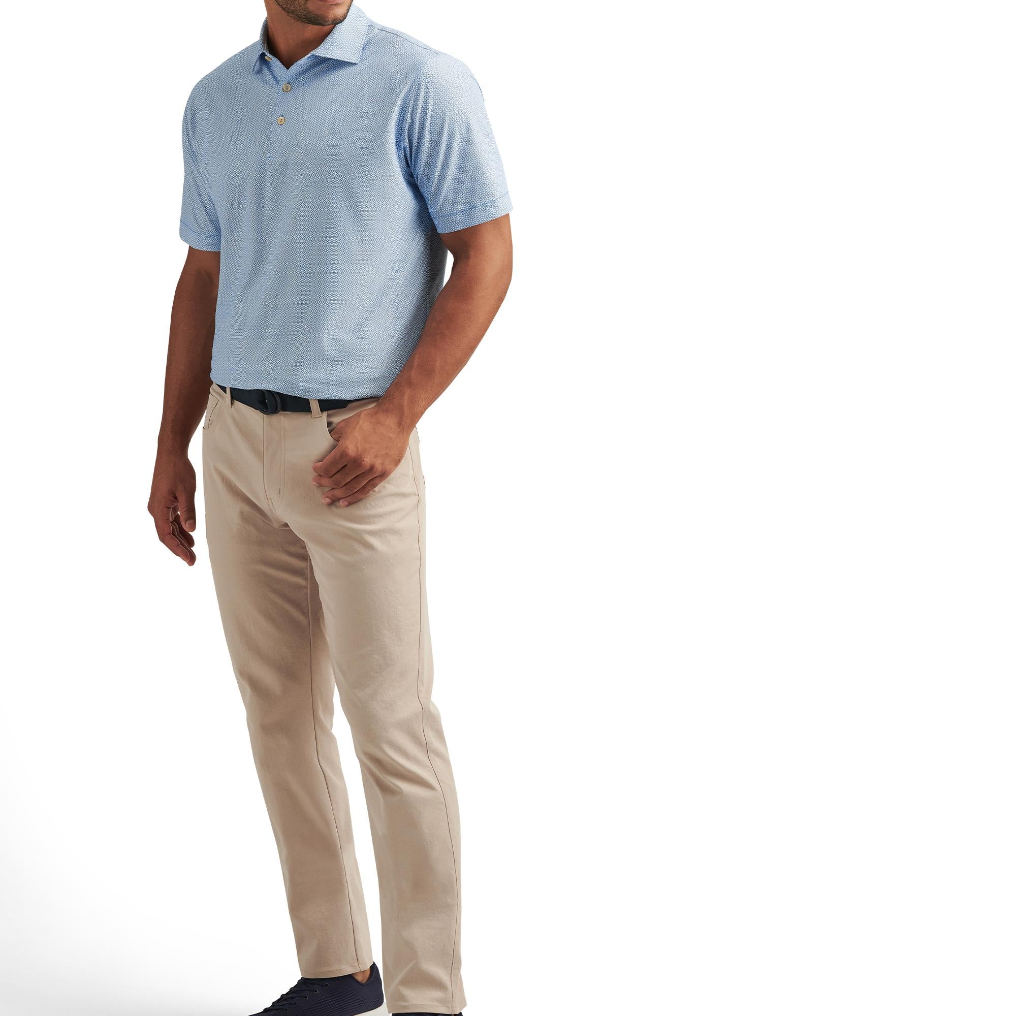 Model front view wearing Peter Millar Costa Geo Polo Shirt in Sailor Blue – luxury golf polo for men
