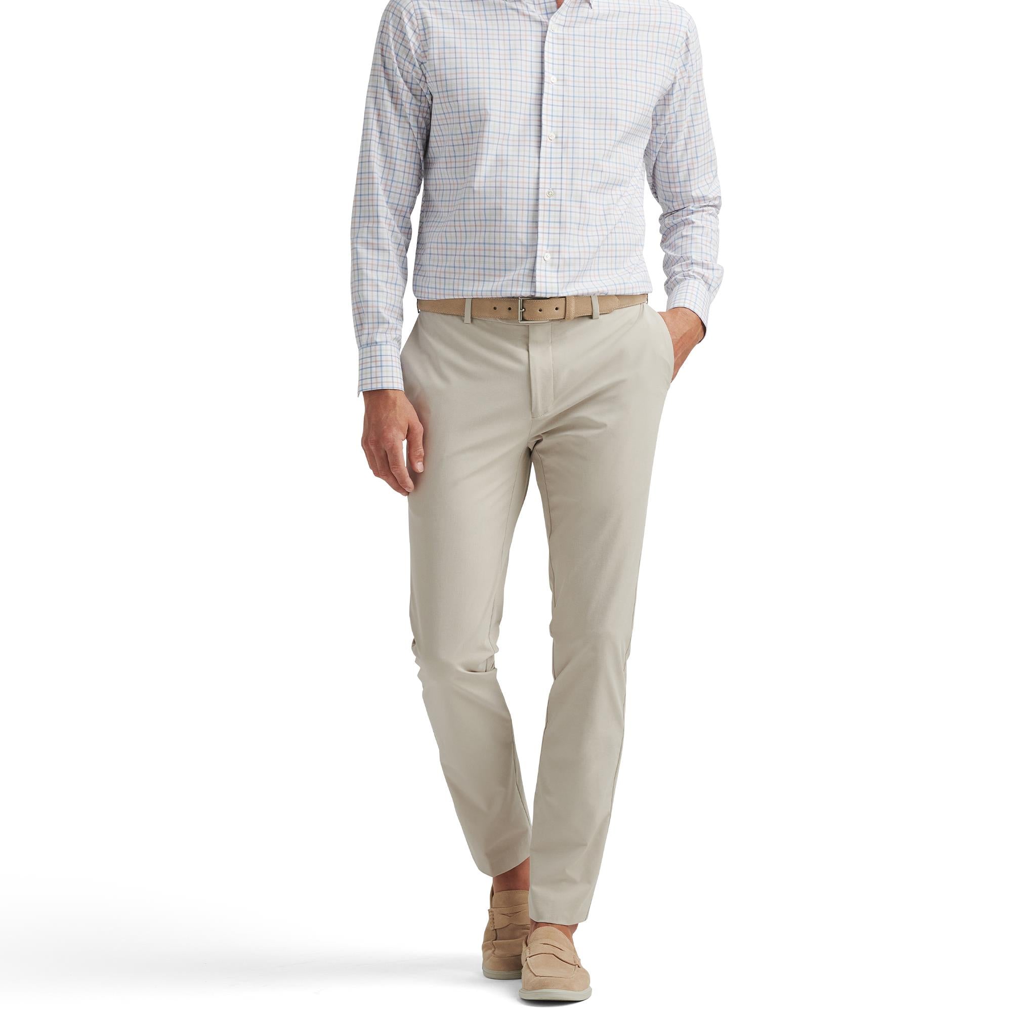 Model front view wearing Peter Millar Surge Performance Trousers in Oatmeal – slim fit golf trousers for men