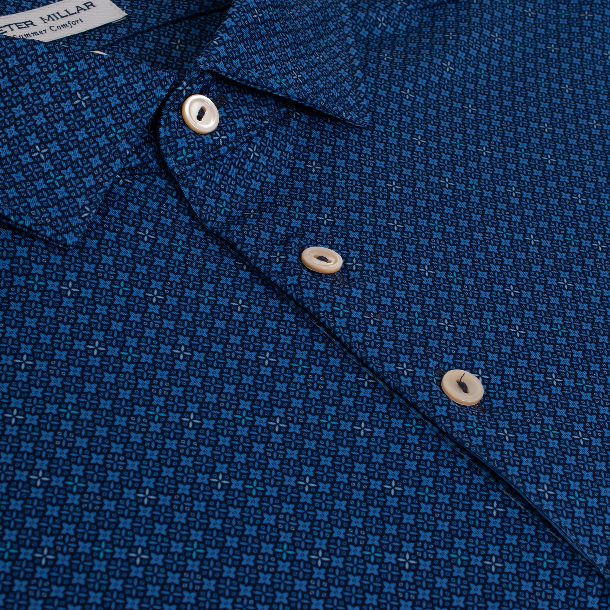 Close-up showing subtle pattern and buttons on Peter Millar Castellina Performance Jersey Polo – designer golf polo
