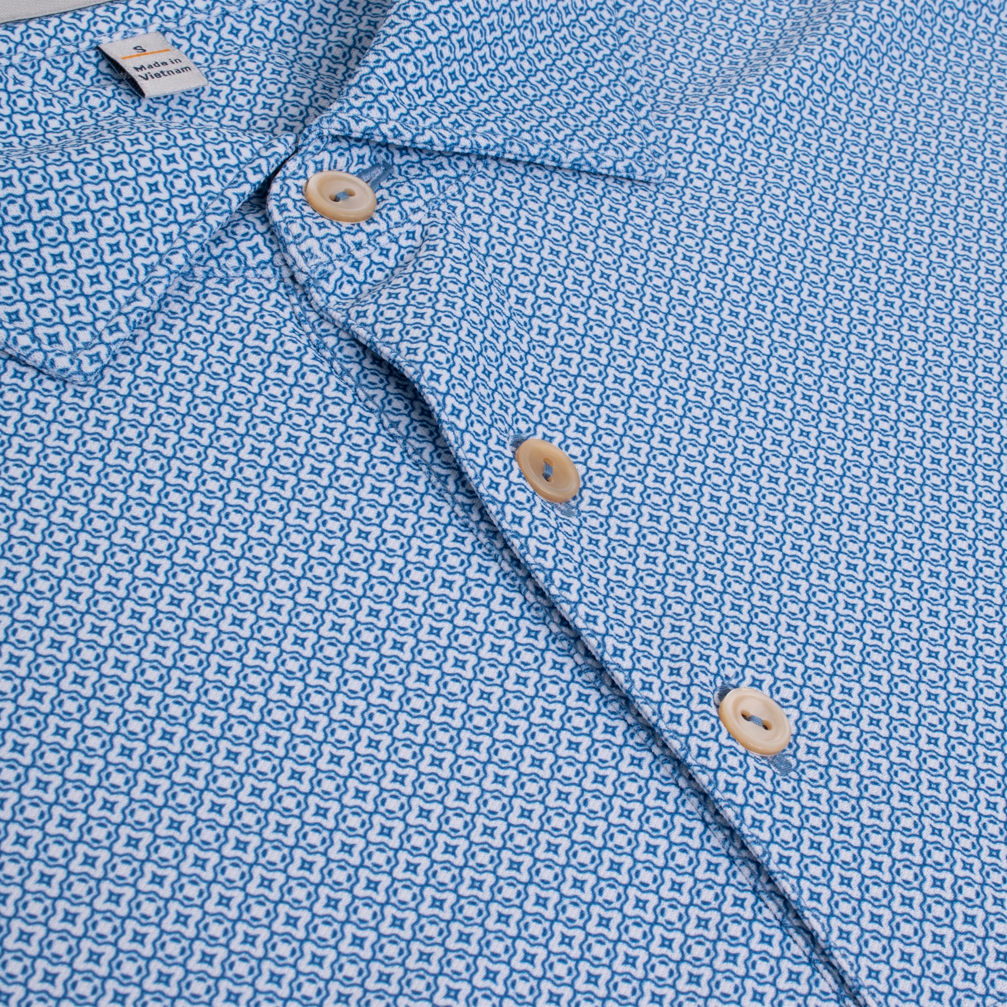 Close-up of micro-pattern and buttons on Peter Millar Costa Geo Polo – breathable mens golf polo shirt