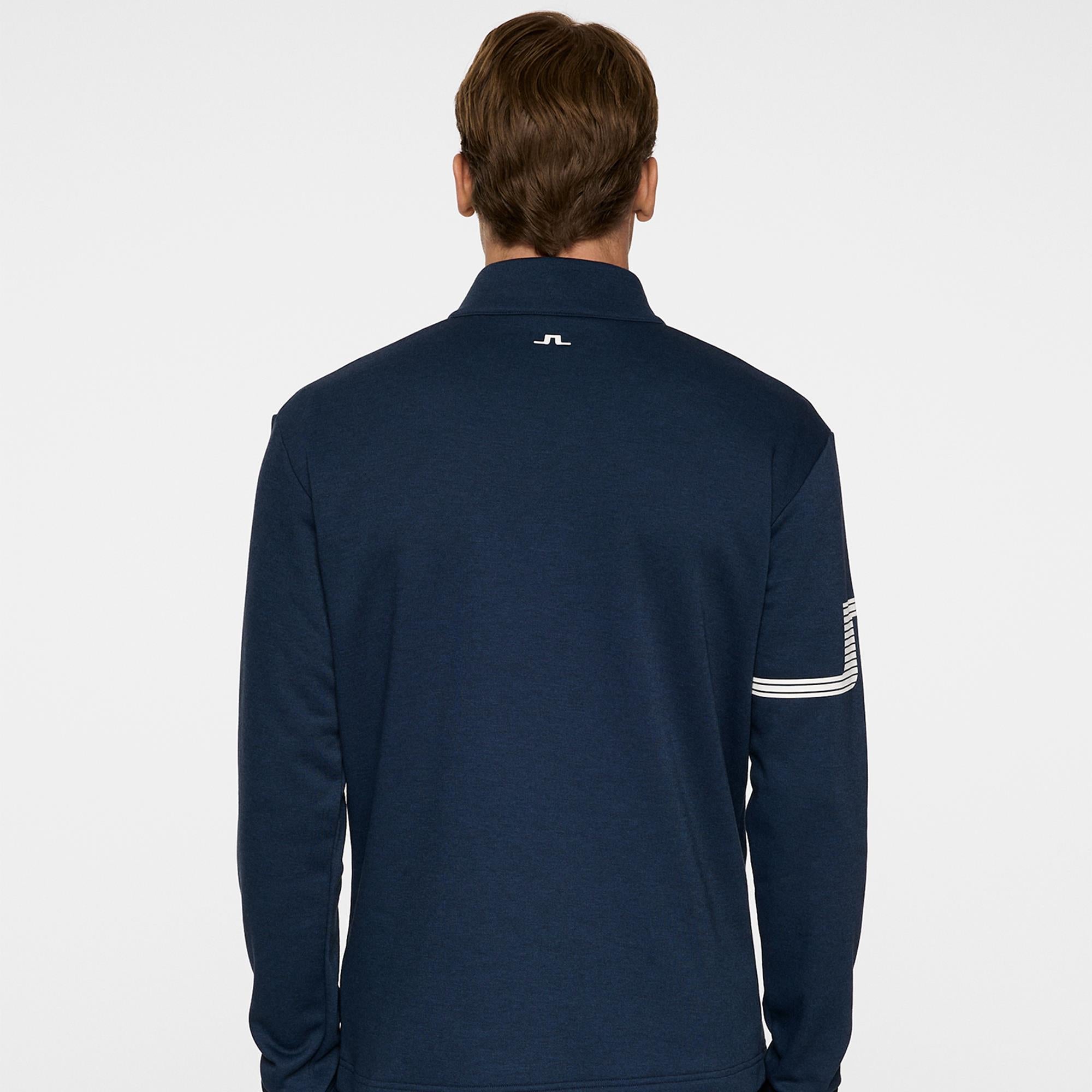 Model back view in J.Lindeberg Heath Strike Golf Mid Layer Navy