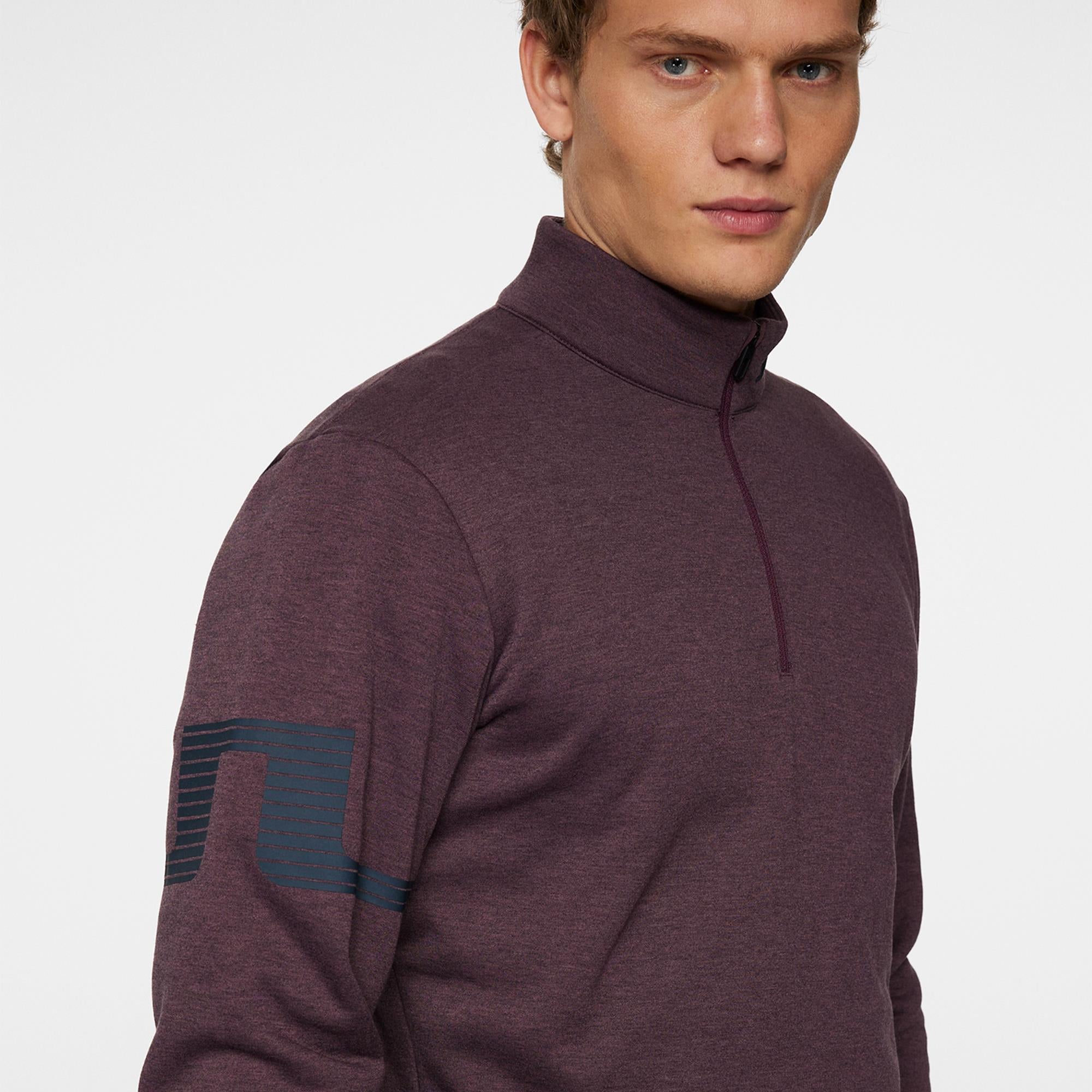 Close-up of rubber Bridge logo on sleeve – Heath Strike Huckleberry Mid Layer