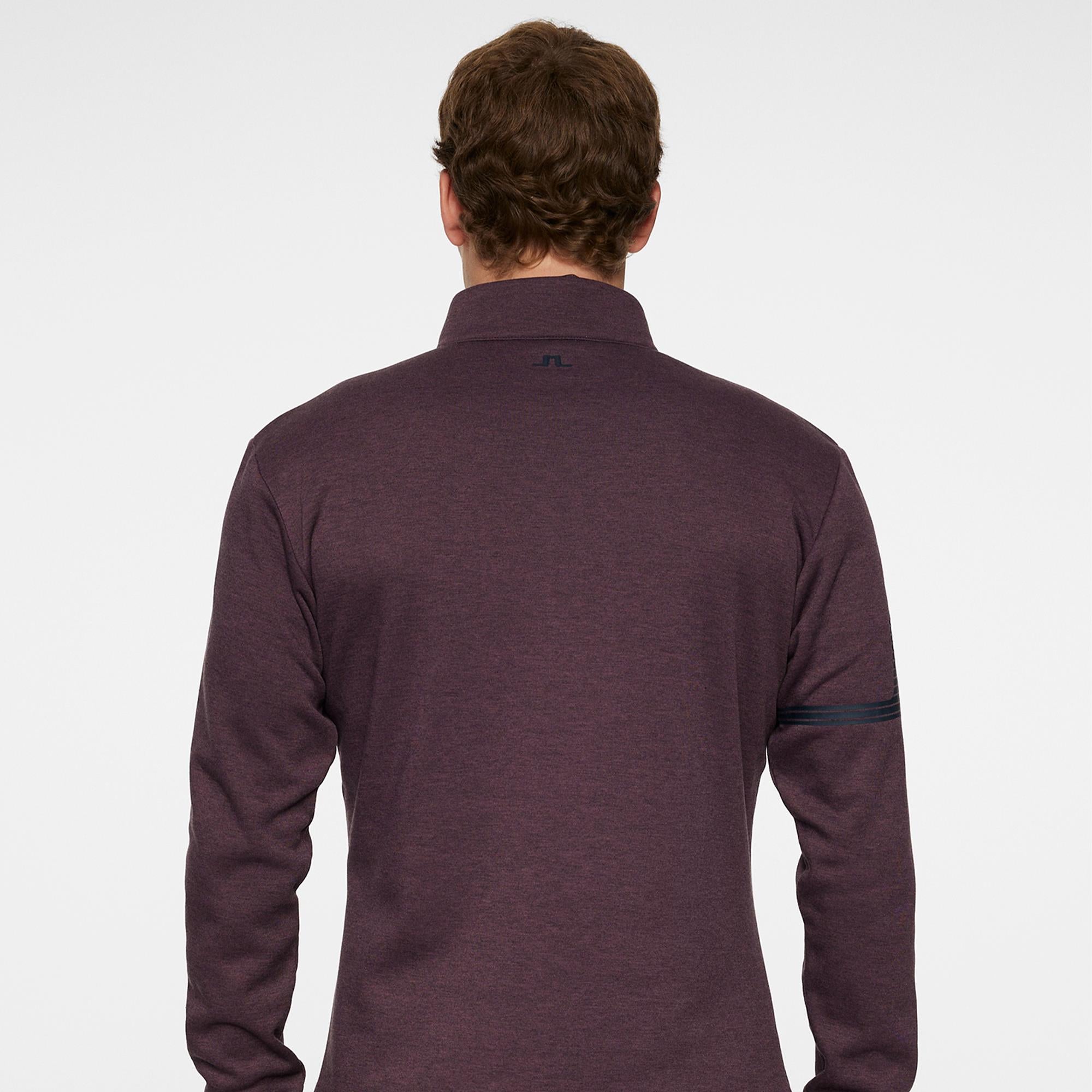 Model back view in J.Lindeberg Heath Strike Golf Mid Layer Huckleberry