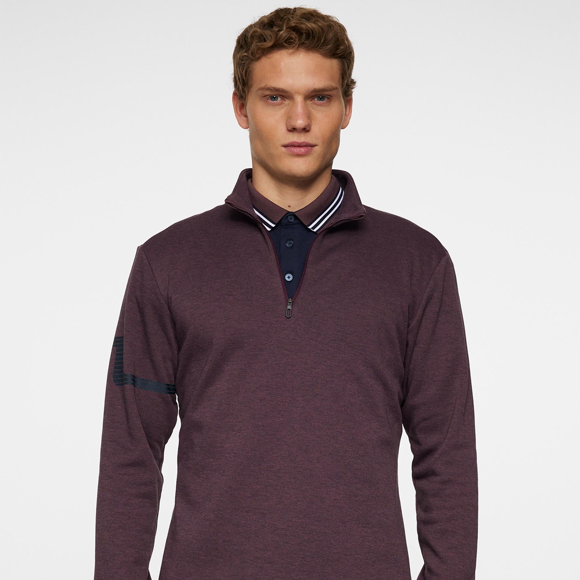 Model front view in J.Lindeberg Heath Strike Golf Mid Layer Huckleberry