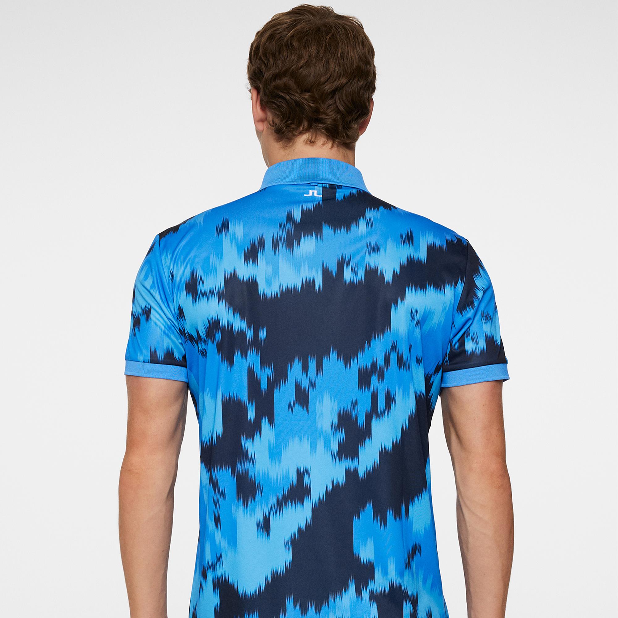 Back model shot showing J.Lindeberg men’s golf polo shirt Warp Sonic Blue
