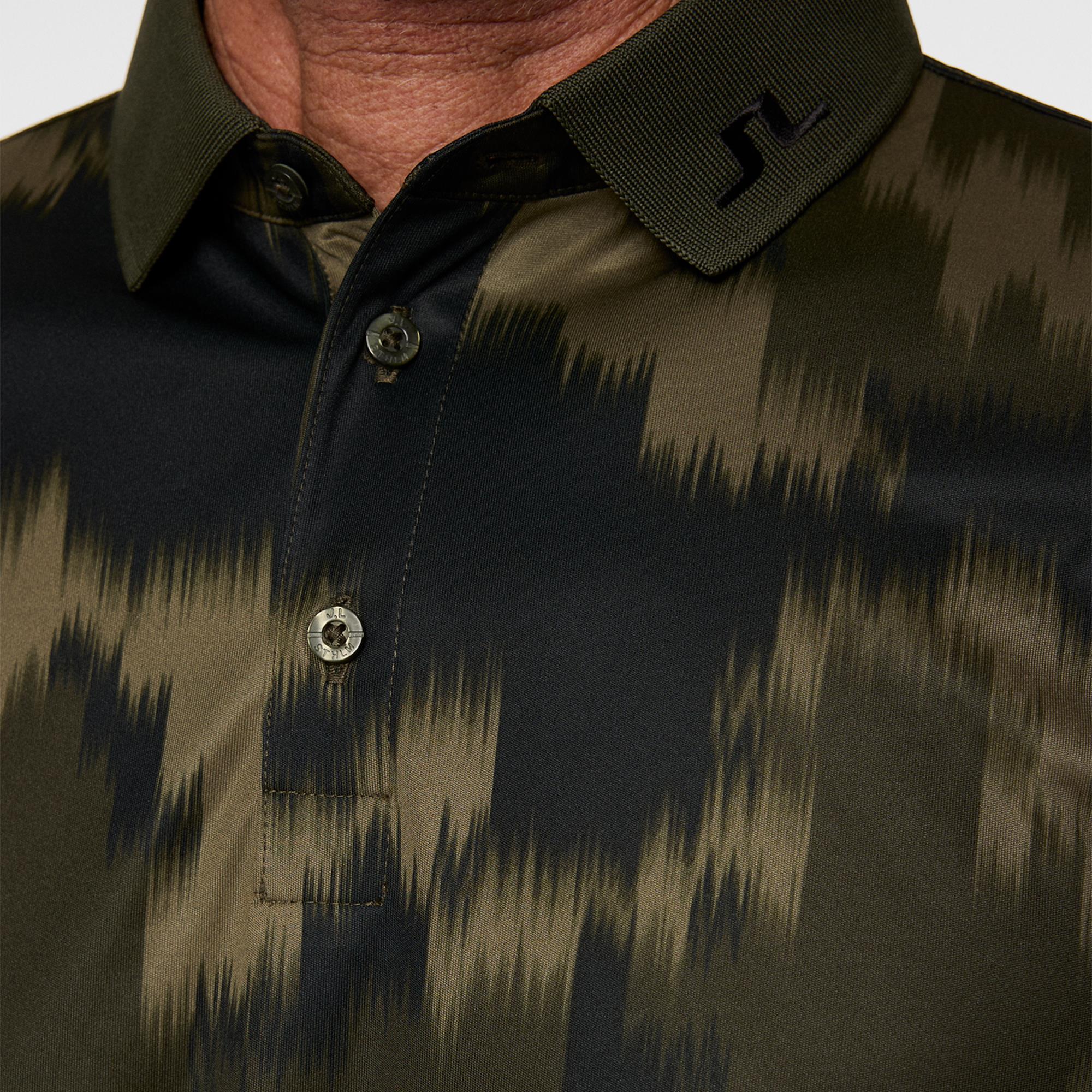 Close-up of J.Lindeberg men’s golf polo shirt collar and fabric detail in Warp Forest print
