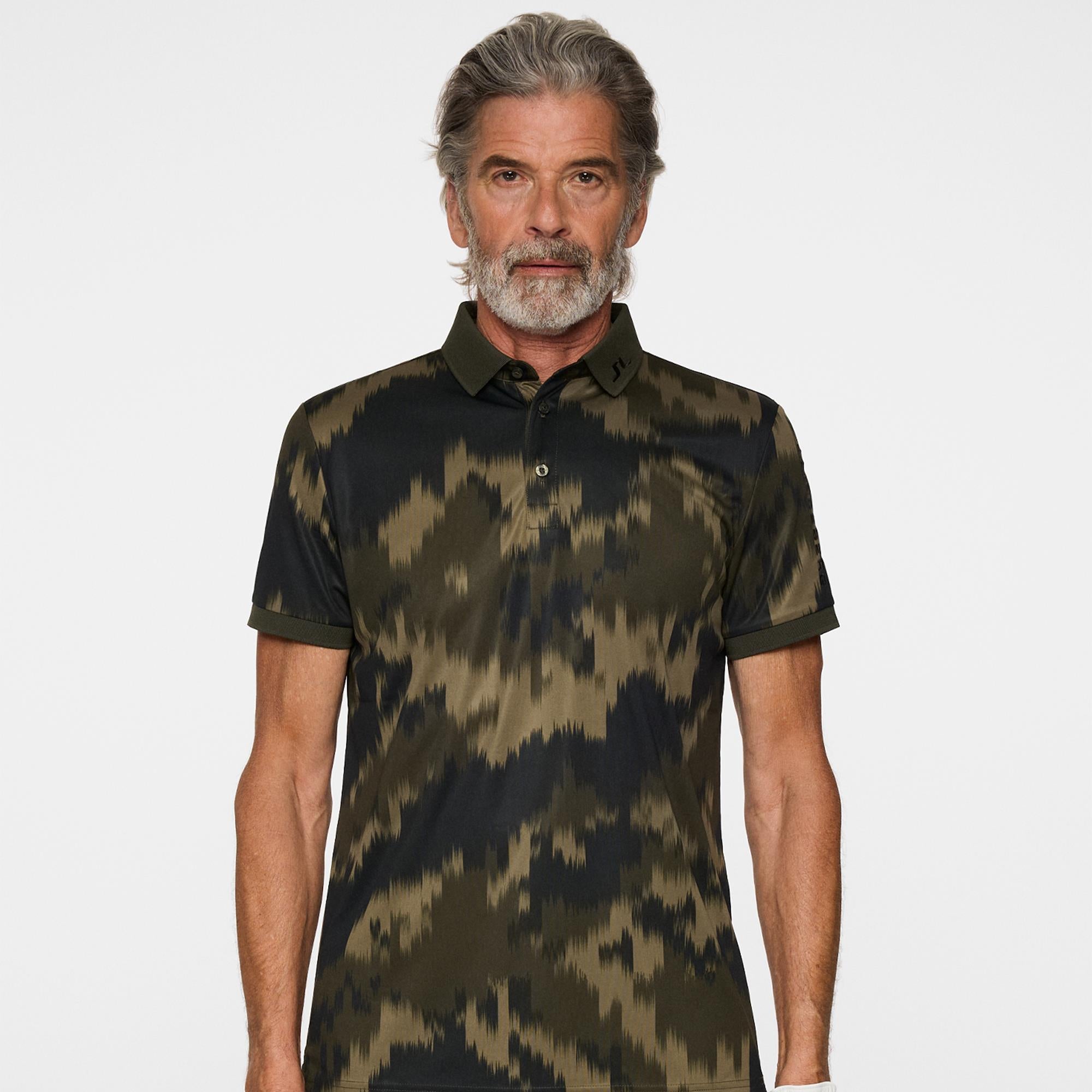 Front view of J.Lindeberg men’s golf polo shirt on model in Warp Forest print